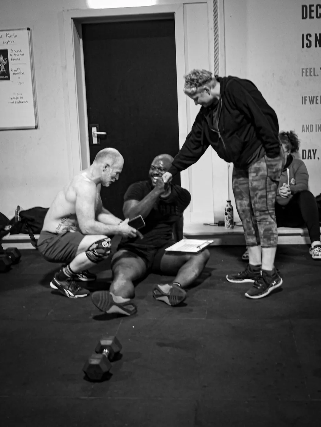 A coach checking in with members after a session at Huntsman
